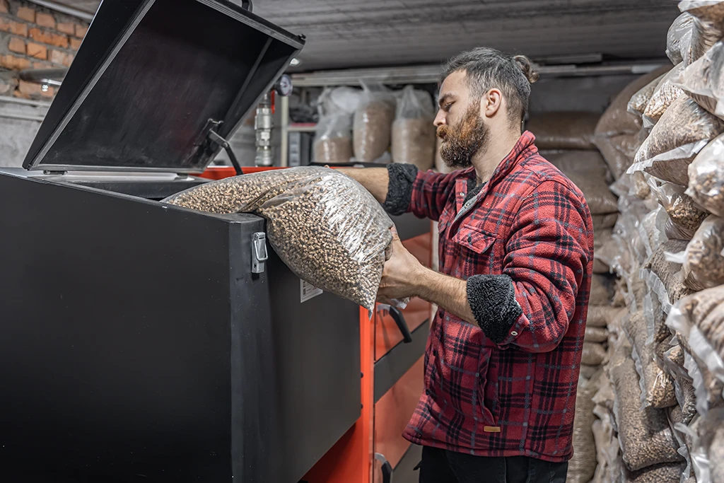the-man-loads-the-pellets-in-the-solid-fuel-boiler
